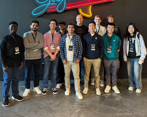 Externs standing in front of a wall