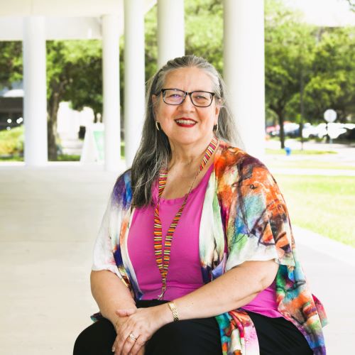 Linda Stokes sitting on campus